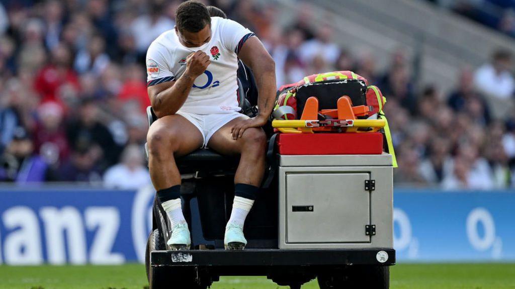 Ollie Lawrence is taken off the pitch on a medical cart
