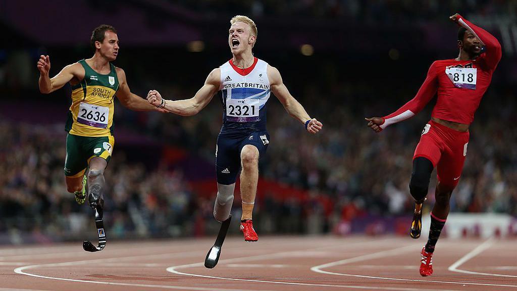 Jonnie Peacock celebrates winning gold in the men's 100m T44 at the 2012 Paralympics