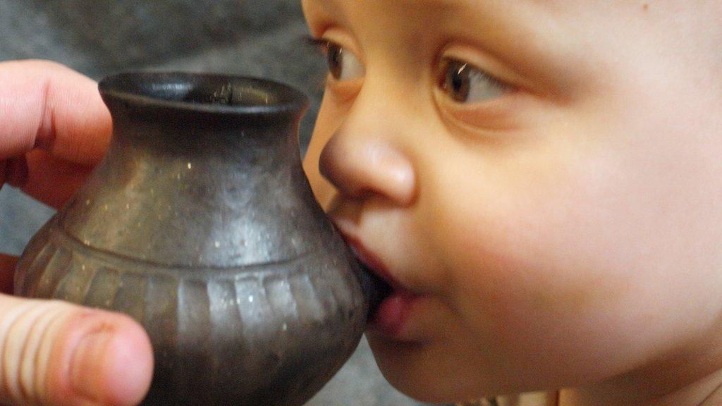 Modern day baby feeding from reconstructed vessel