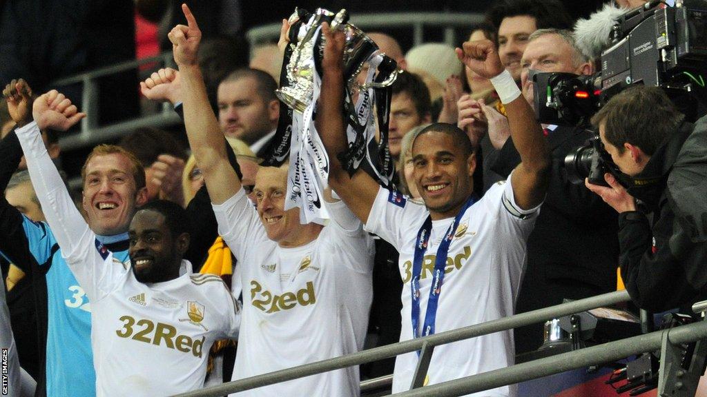 Ashley Williams lifts the Capital One Cup with club captain Garry Monk, who came off the bench in the final