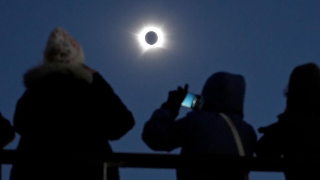 A view shows the sun almost entirely obscured by the moon as seen from a cruise ship off Greenland