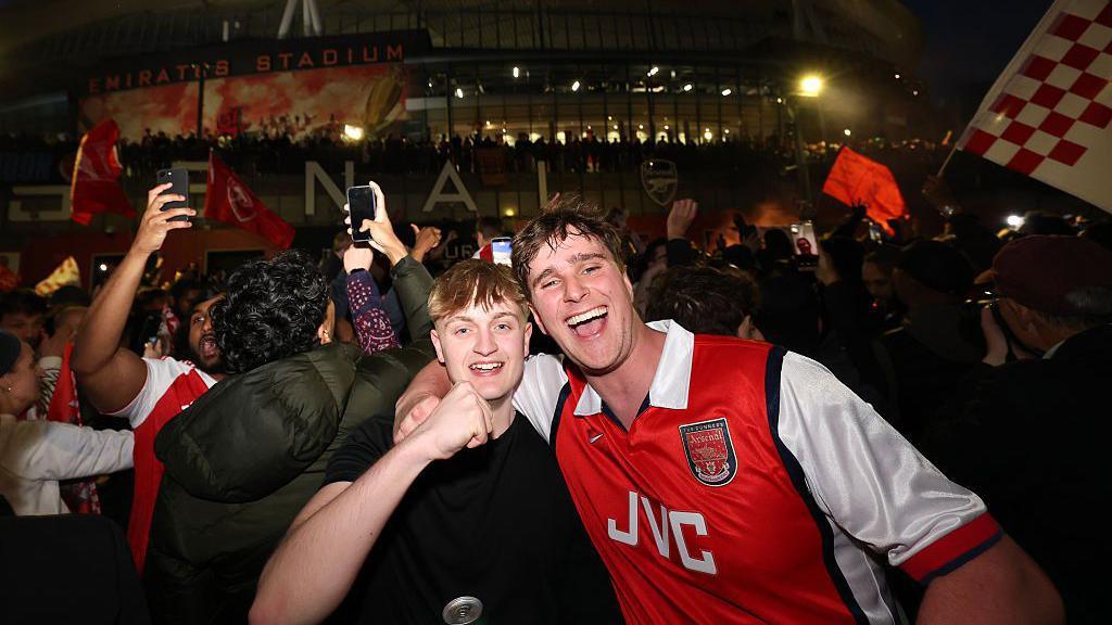 Arsenal fans celebrate the Gunners winning the Premier League title