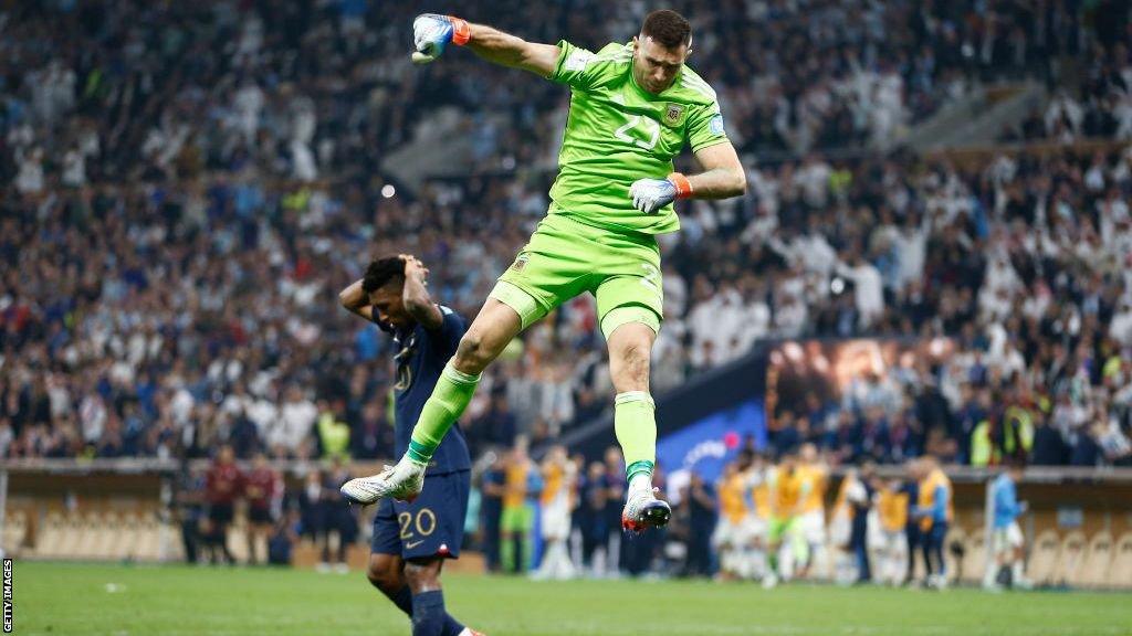 Emiliano Martinez celebrates after saving a penalty in the World Cup final