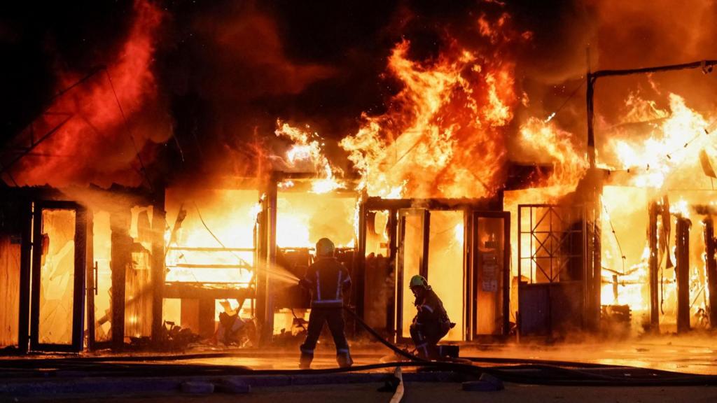 Firefighters work at a site of a book market hit by a Russian missile strike