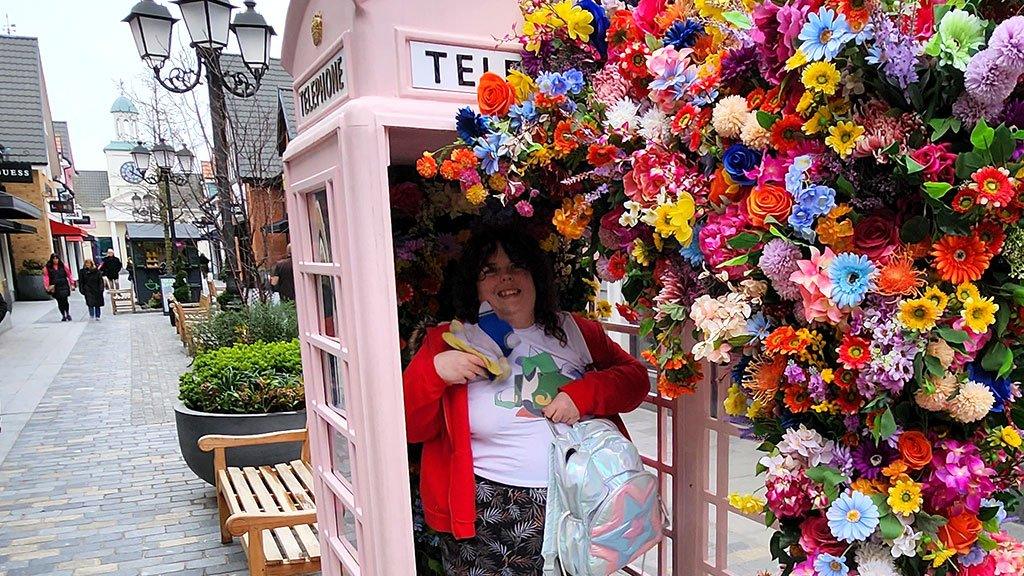 Alex in a telephone box