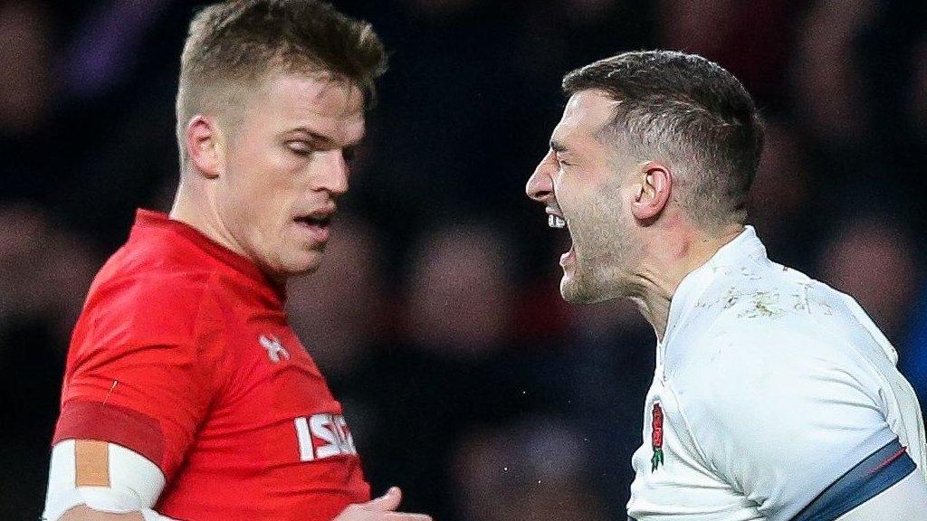 England's Jonny May celebrates scoring a try as Wales' Gareth Anscombe looks on