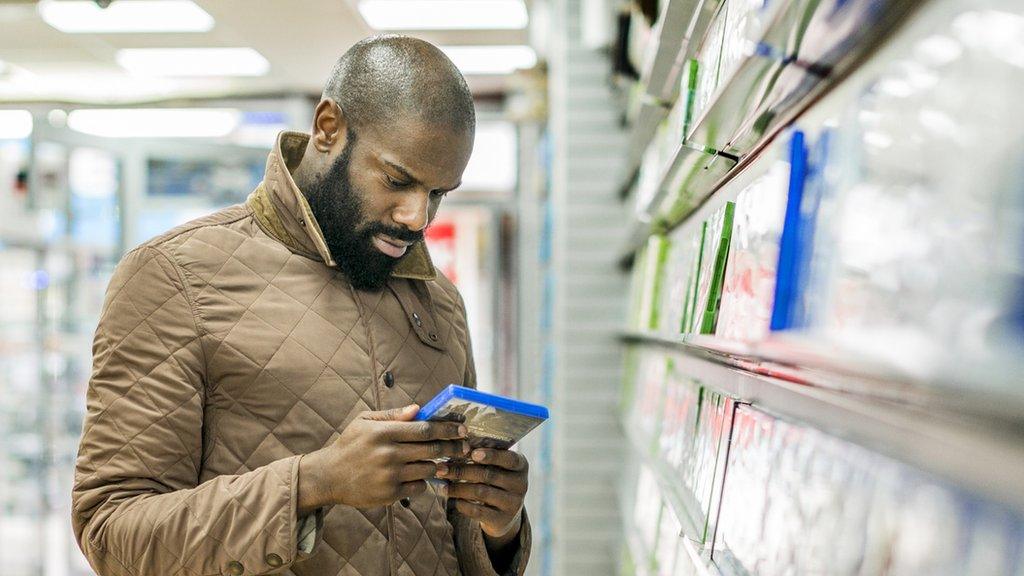 A stock image of a man buying computer games