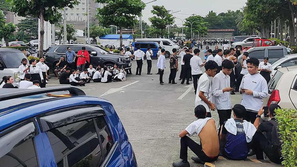 Employees at a shopping mall gather outside the building in Davao City, on the southern island of Mindanao on October 10, 2025, after a 7.4-magnitude earthquake struck off the southern Philippines. Employees at a shopping mall gather outside the building in Davao City, on the southern island of Mindanao on October 10, 2025, after a 7.4-magnitude earthquake struck off the southern Philippines.