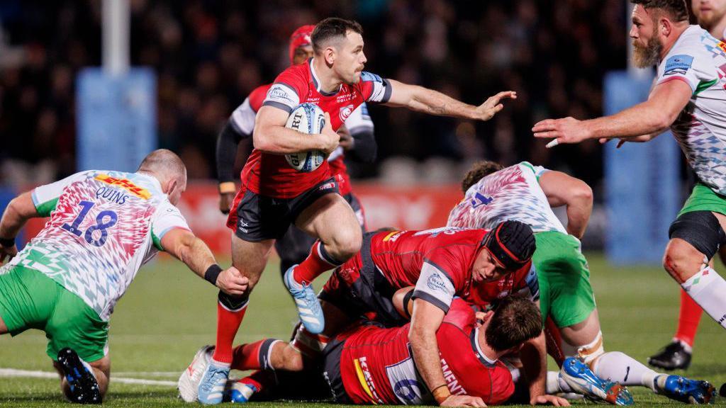 Tomos Williams runs with the ball for Gloucester