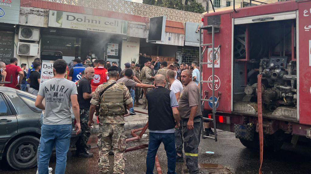  first responders gather at the scene of a reported device explosion in Saida in southern Lebanon 