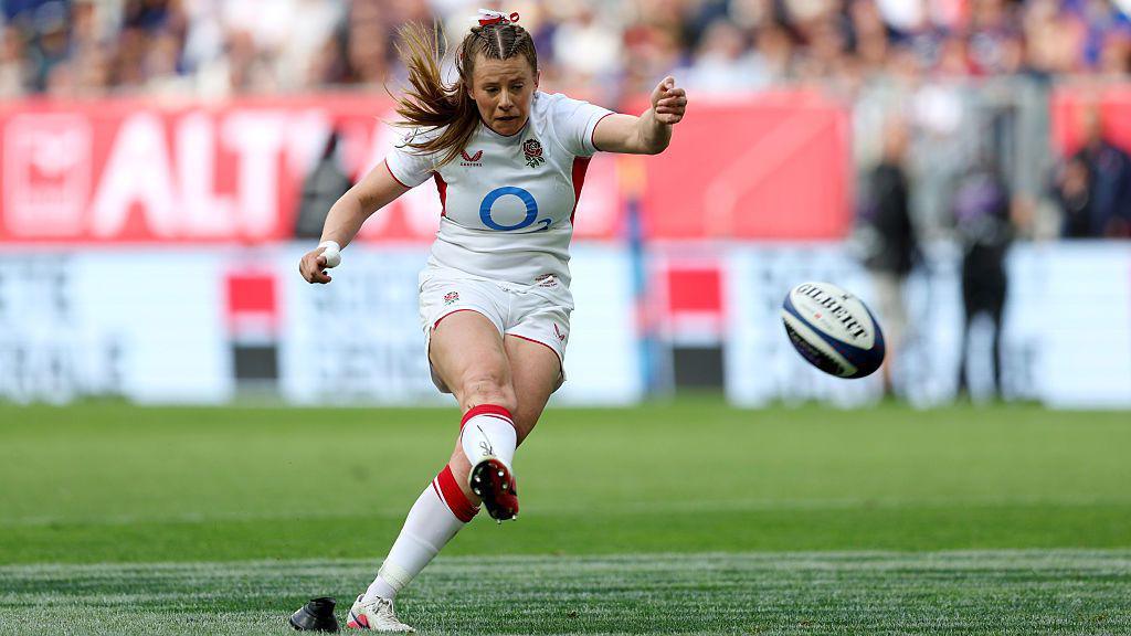 Zoe Harrison kicking the rugby ball