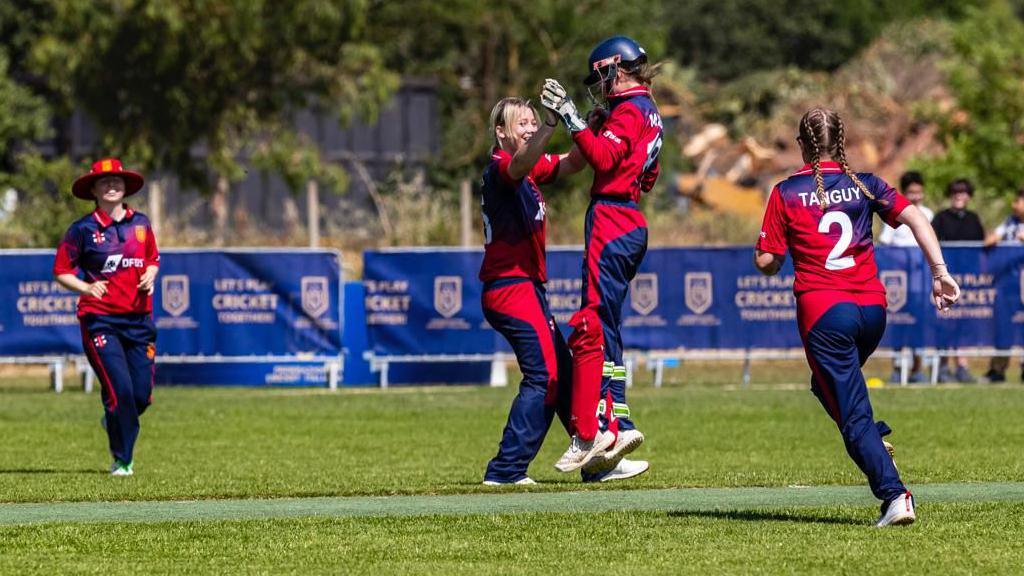 Jersey's bowlers celebrate a wicket