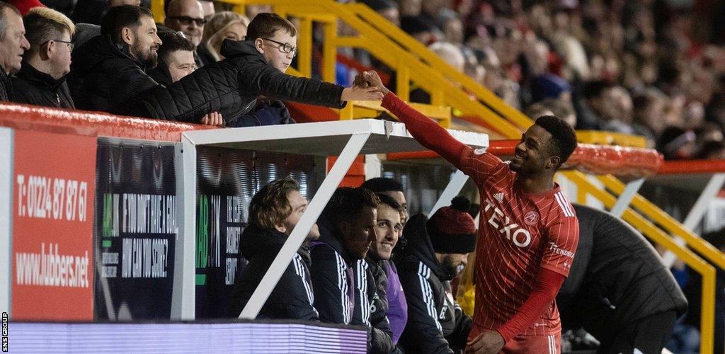 Aberdeen's Luis Lopes shakes hands with a fan during a cinch Premiership match between Aberdeen and St Johnstone at Pittodrie