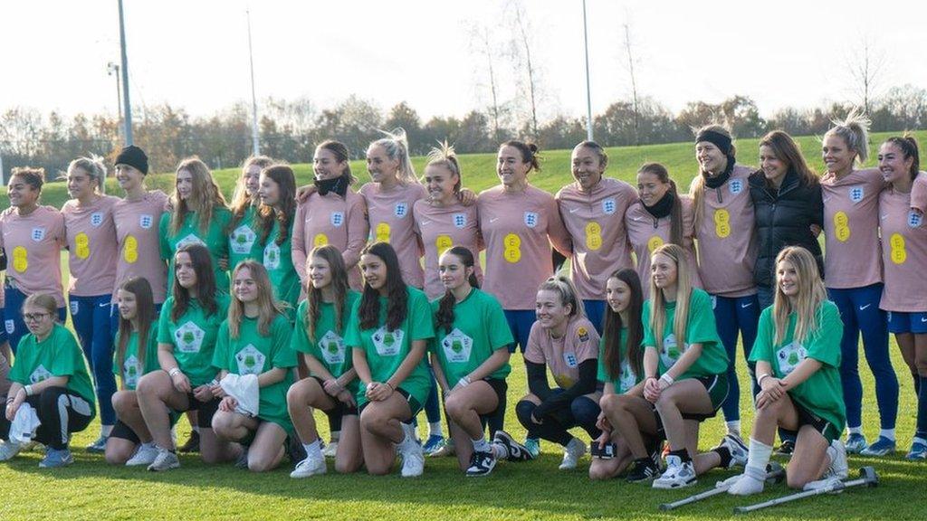 England's Lionesses with young female footballers