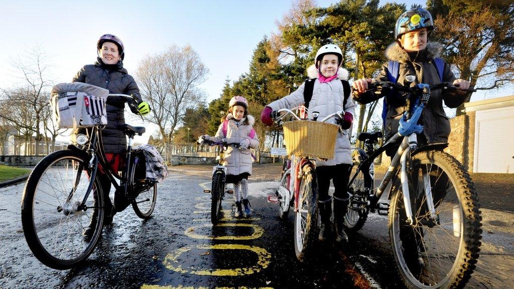 Family cycling to school