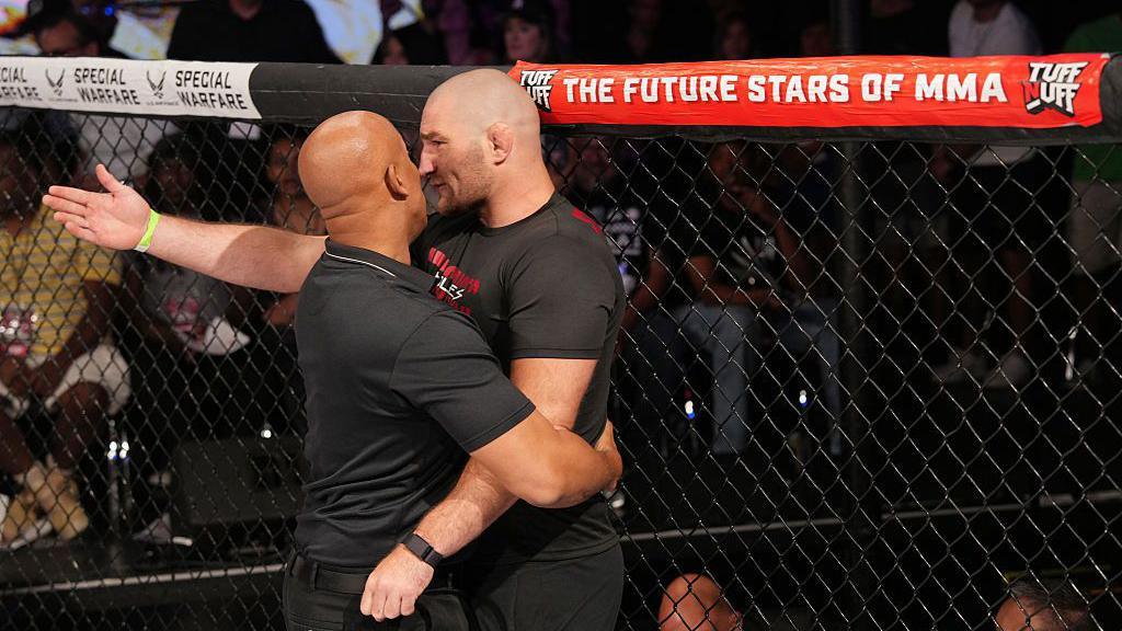 Security grabs Sean Strickland in the cage