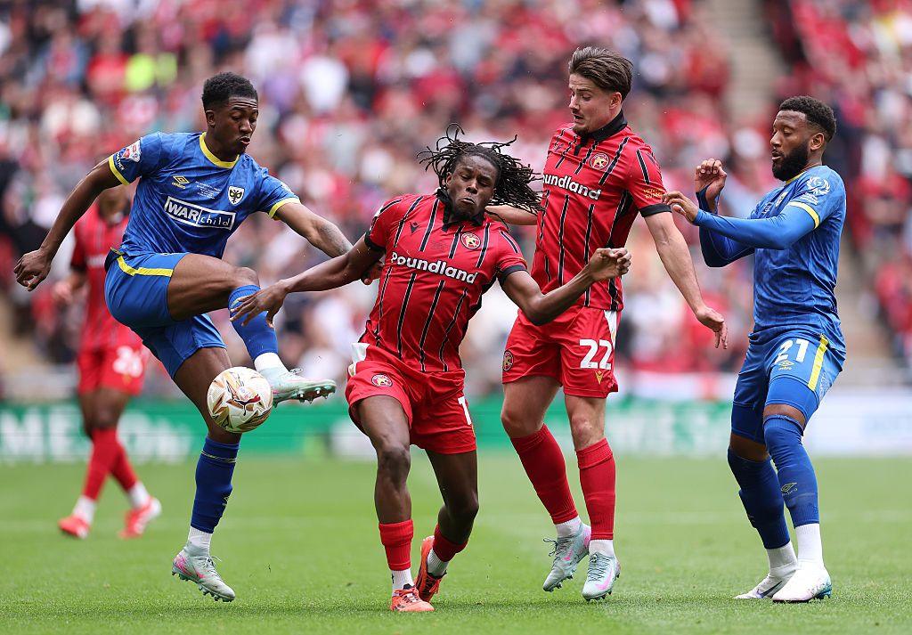 Nathan Asiime, second left, in action against AFC Wimbledon