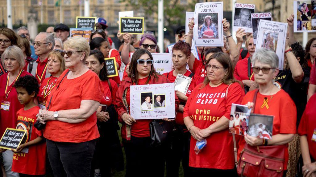 People affected by the infected blood scandal attend a vigil in Parliament Square on May 19, 2024 in London, England. 