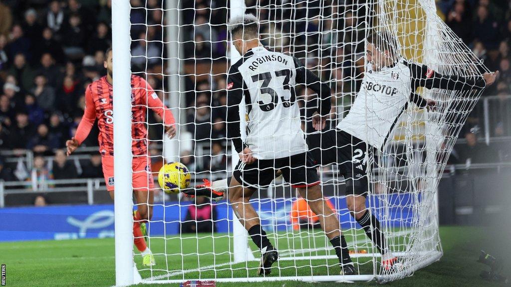 Fulham's Timothy Castagne clears the ball off the line v Everton