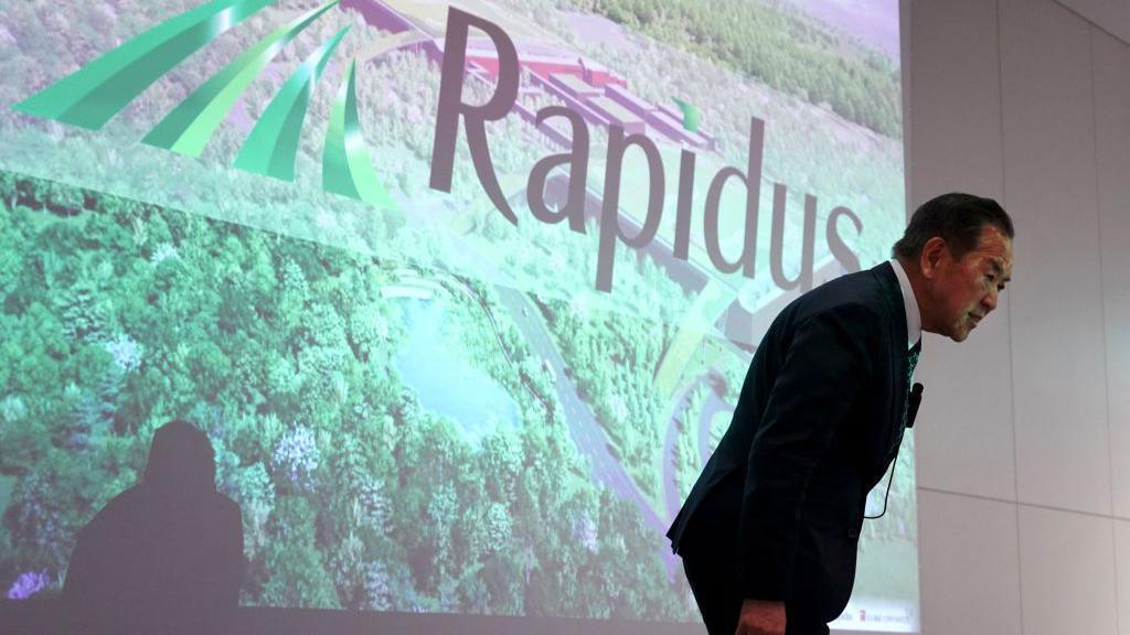 Rapidus Corporation President Atsuyoshi Koike bows during a press conference in Tokyo