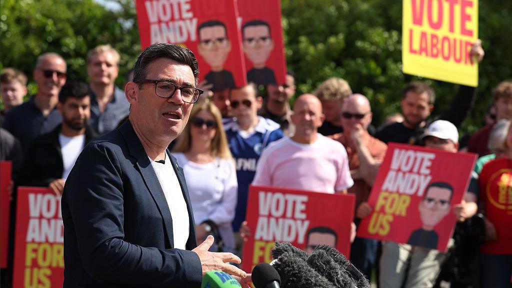 Andy Burnham standing with Labour supporters campaigning in Makerfield.