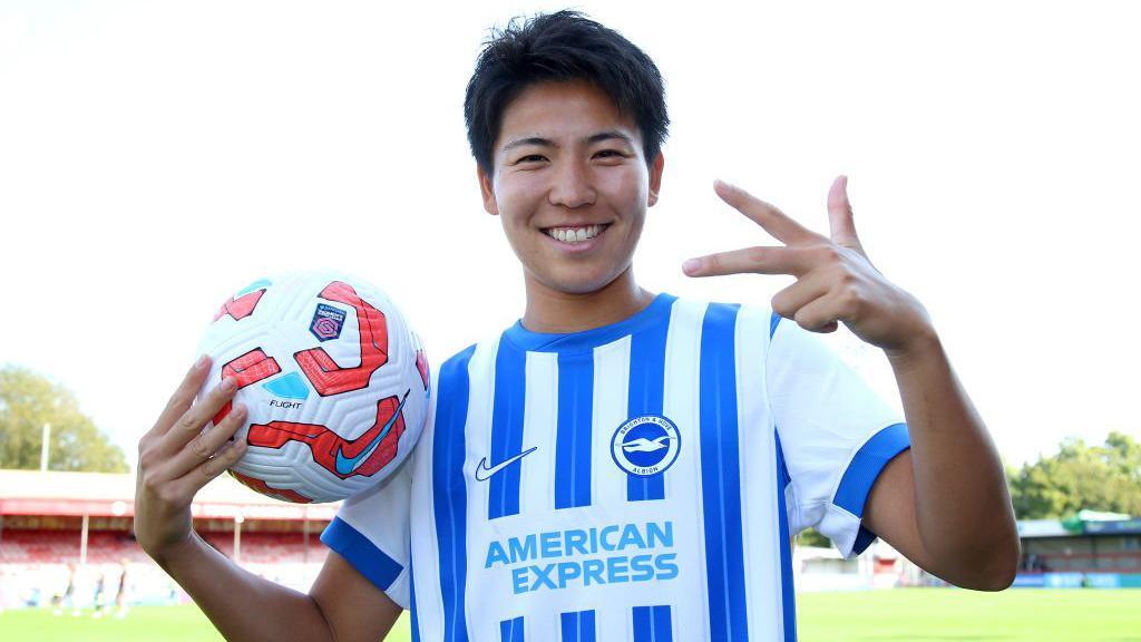 Brighton's Kiko Seike poses with the match ball