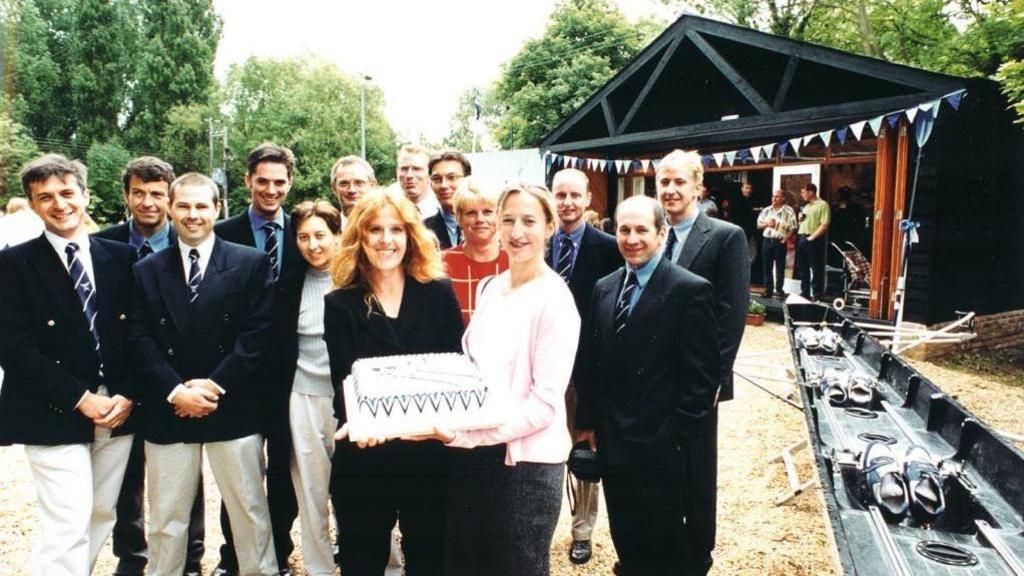 Members of Sudbury Rowing Club holding a celebration cake