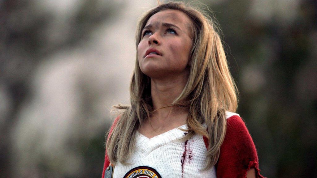 Hayden Panettiere as Claire Bennet on the superhero series Heroes. She has dirt marks on her face and jumper