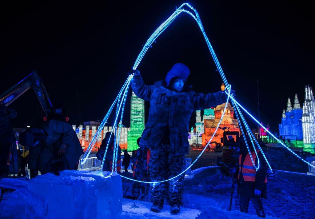 A worker gets light ready for the Harbin ice and snow festival