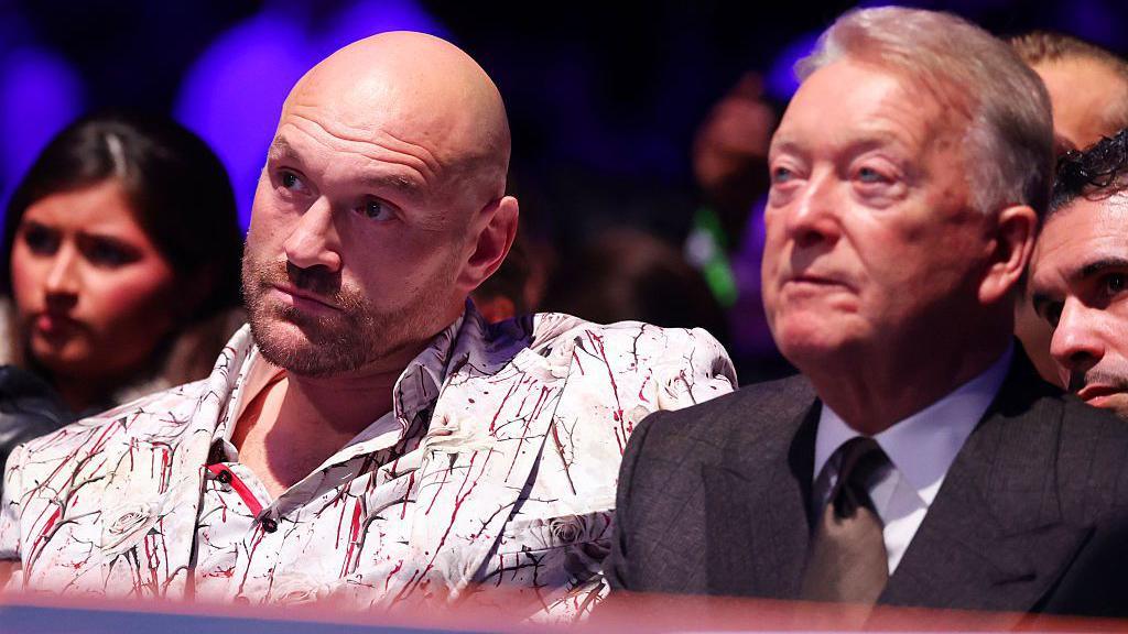 Tyson Fury sitting next to Frank Warren