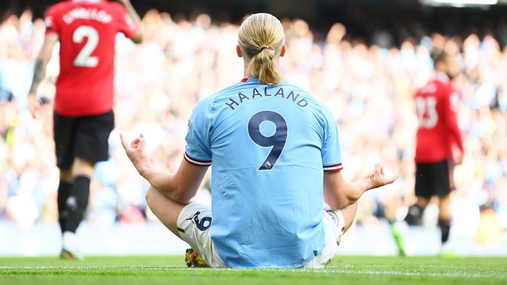 Haaland sitting down on the pitch