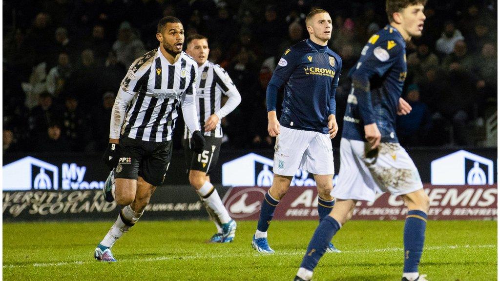 Mikael Mandron watches on as his strike squirms under Trevor Carson