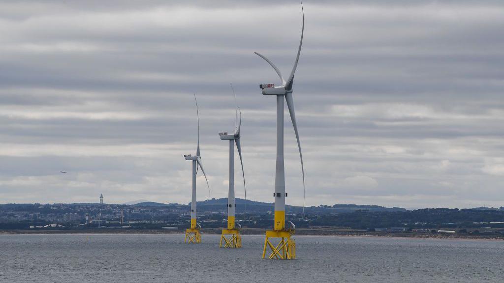 Wind turbines standing on platforms in the sea