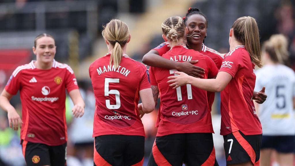 Manchester United players celebrate Melvine Malard's goal against Leicester City in the WSL on Sunday