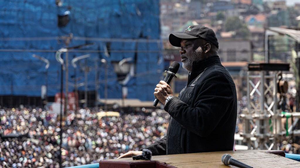 The leader of the allied rebel groups Corneille Nangaa looks out at a crowd during a rally in eastern DR Congo 