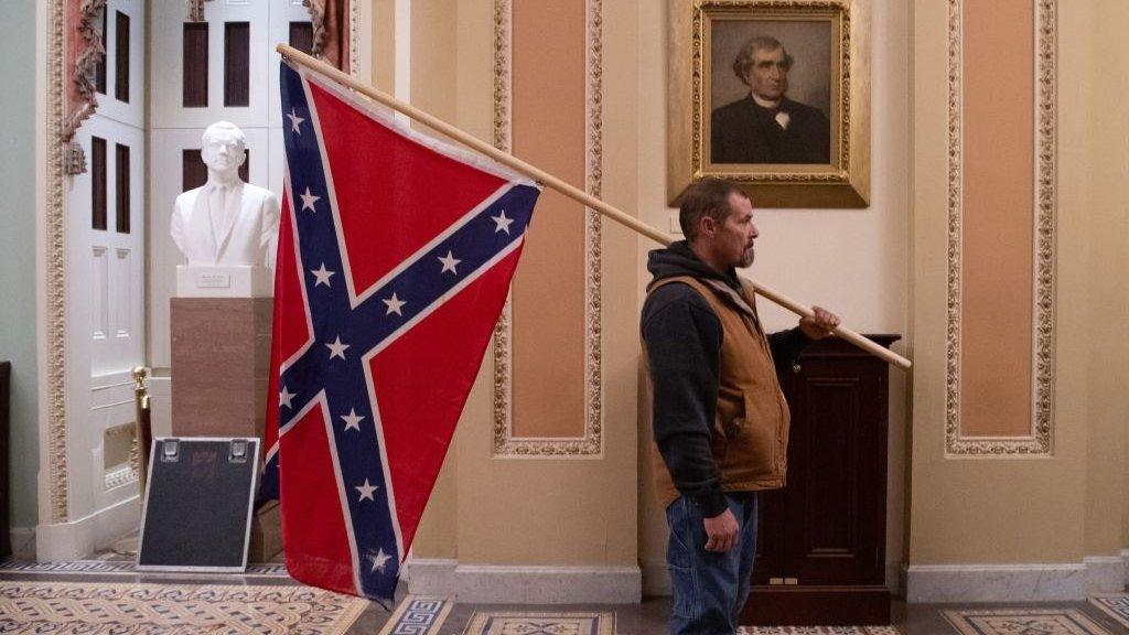 Photo of Kevin Seefried holding the Confederate flag