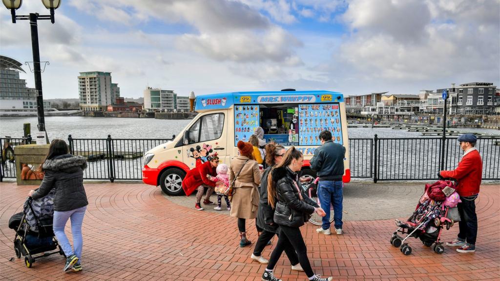 People queue for an ice-cream van in Cardiff Bay