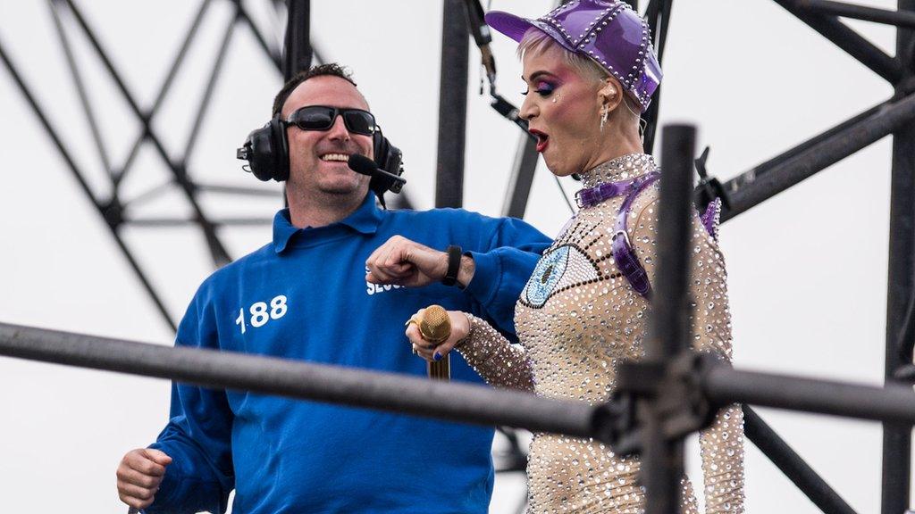 Katy Perry dances with a security guard