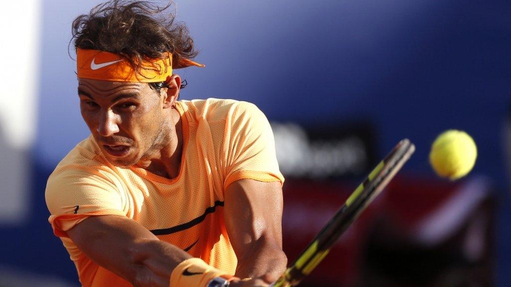 Rafael Nadal plays a backhand