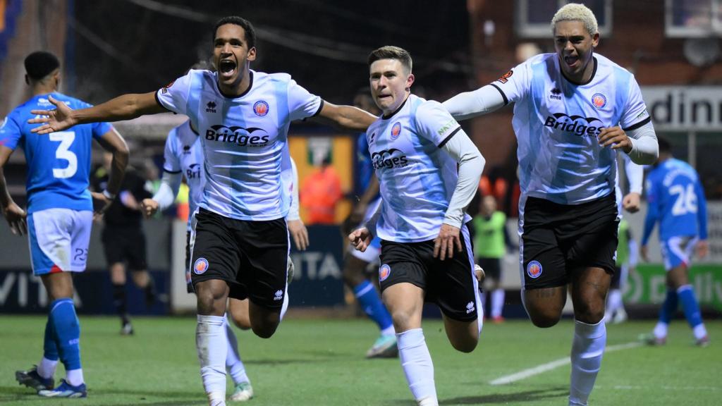 Aldershot players celebrate their goal against Stockport