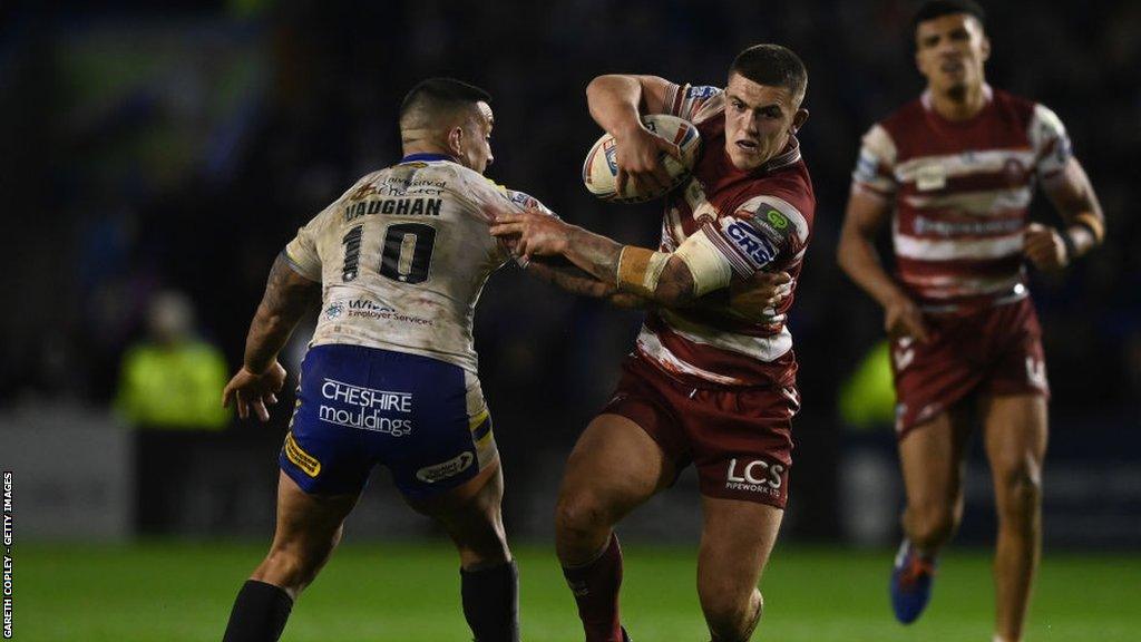 Brad O'Neill carries the ball for Wigan against Warrington