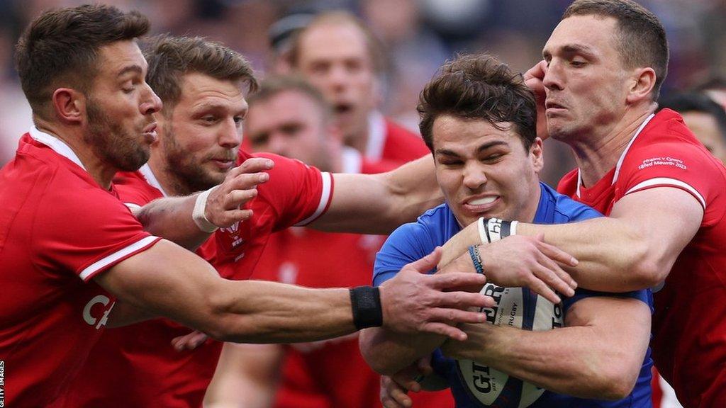 L-R: Rhys Webb and Dan Biggar move in as Antoine Dupont tries to break free of George North