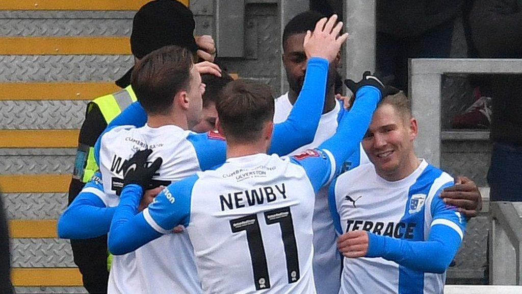 Barrow players celebrate a goal