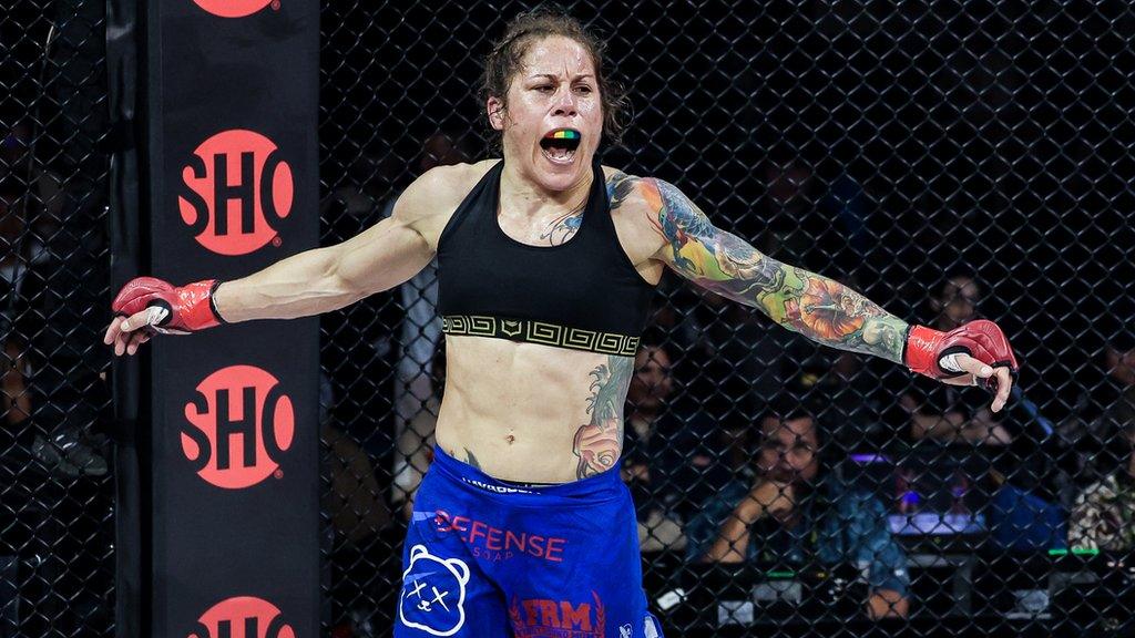 Liz Carmouche celebrates a win in the cage