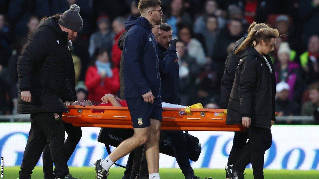 Jordan Davies is stretchered off against Farnborough