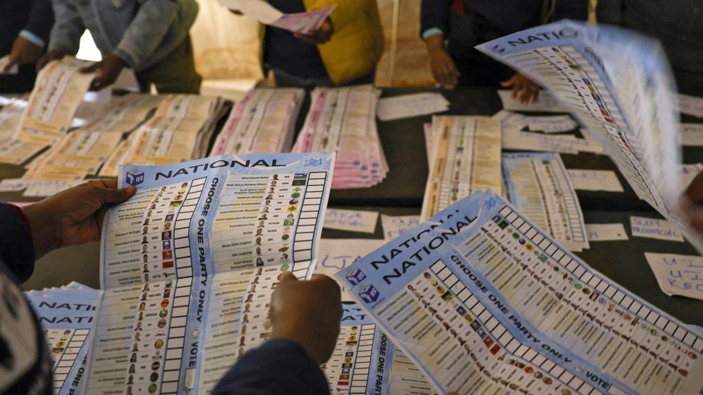 Independent Electoral Commission (IEC) officials sort ballots during counting at Itereleng informal settlement polling station in Pretoria on May 29, 2024