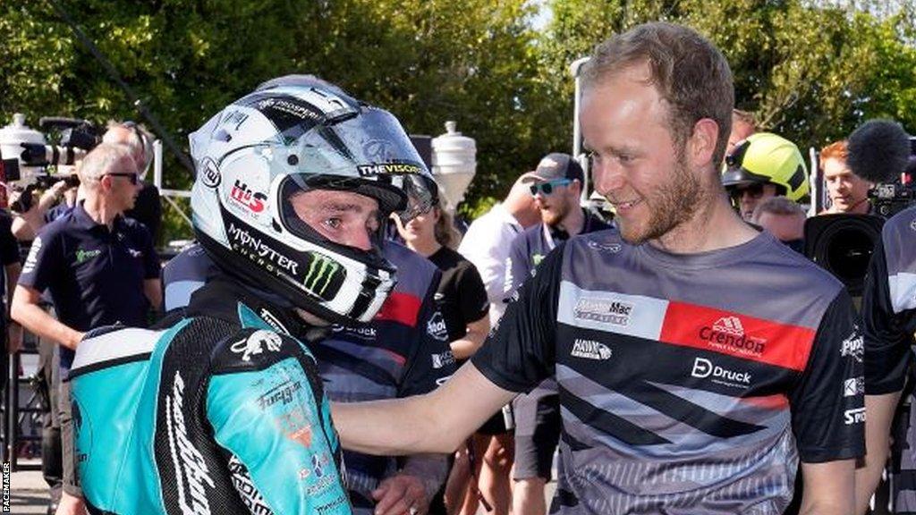 Michael Dunlop celebrates winning the Superbike race with Steve Hicken of Hawk Racing