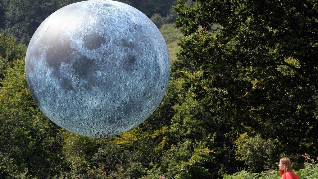 girl looking at moon balloon