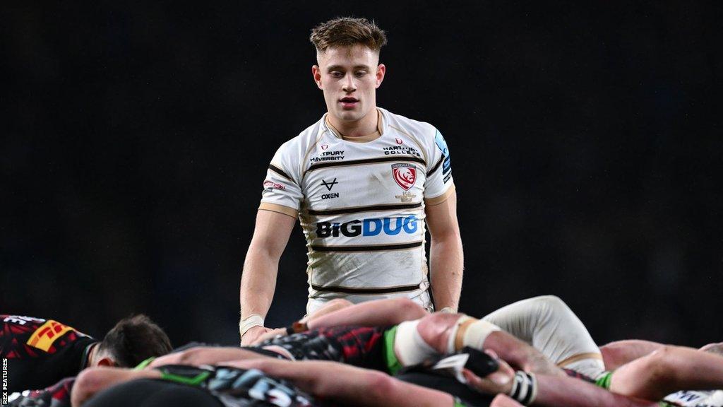 Stephen Varney standing next to a scrum