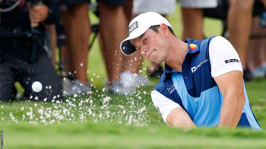 Viktor Hovland hitting a shot out of a bunker in the final round of the Tour Championship